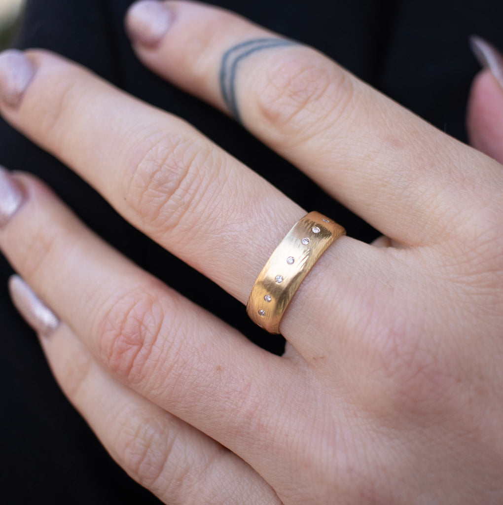 Handmade 18kt gold ring with a row of diamonds. Alternative engagement ring or wedding band on model.