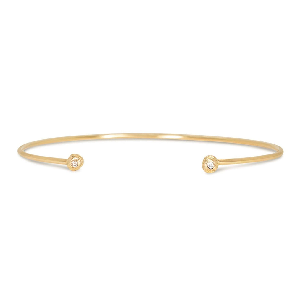Handmade cuff bracelet in 18kt gold with diamonds.