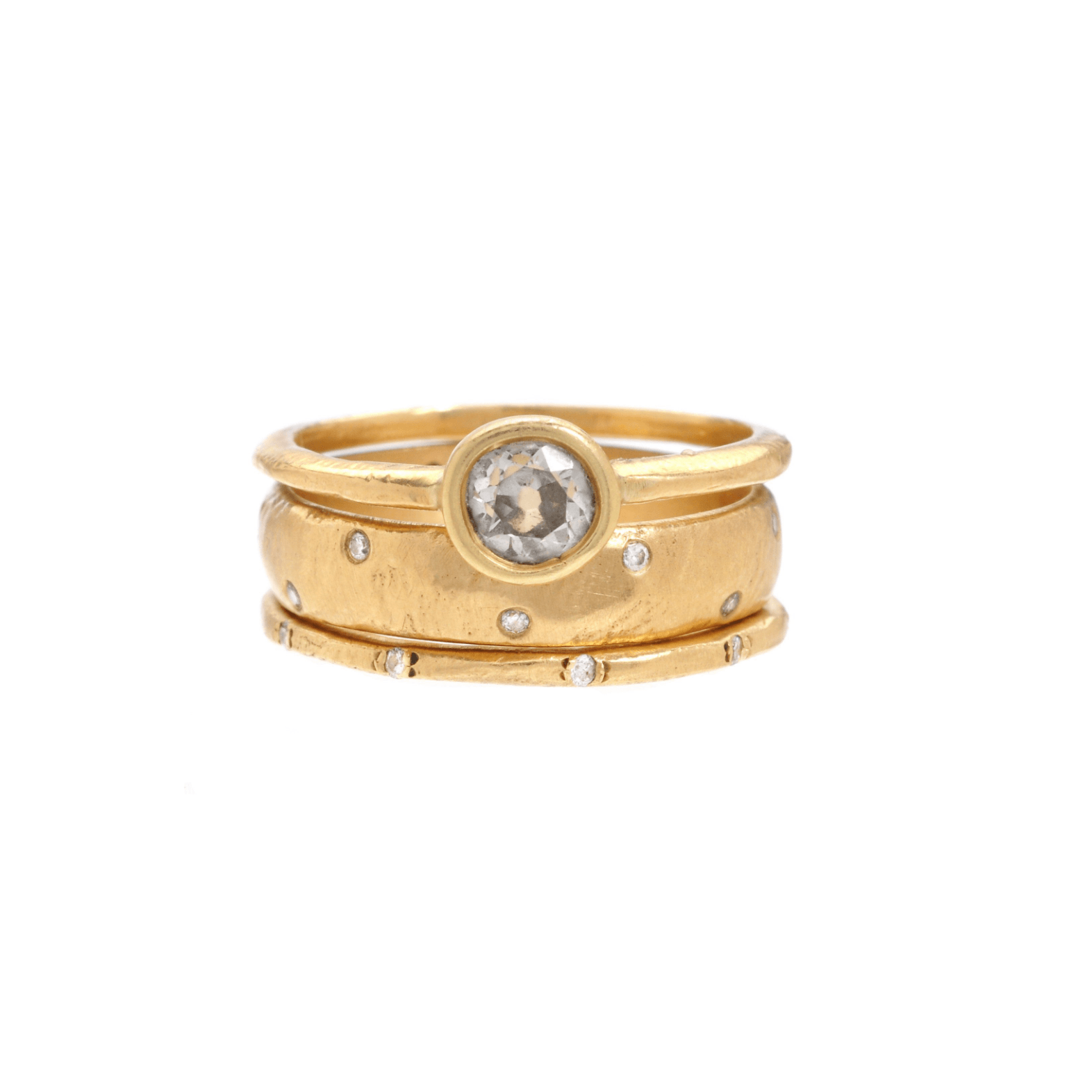 Handmade 18kt gold ring stack. Diamond engagement ring with two diamond wedding bands.